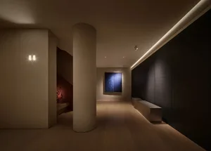 An interior space featuring minimalist design elements and wooden flooring.