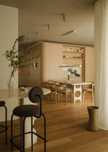 A minimalist interior design featuring wooden furniture and glass elements