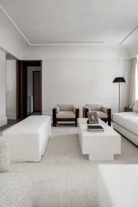 A minimalist living room featuring cotton furniture and neutral tones.