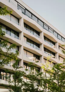 Modern apartment buildings with concrete facades and balconies.