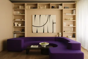 A modern living room with a purple curved sofa, shelves filled with books and decorative items, and a large abstract painting