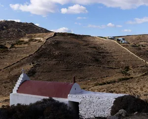 White-roofed stone buildings on a mountain top