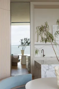 A minimalist residential kitchen featuring marble countertops and a modern, sleek design.