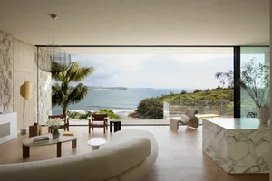 Modern minimalist residential space featuring marble, wood, glass and stone materials.