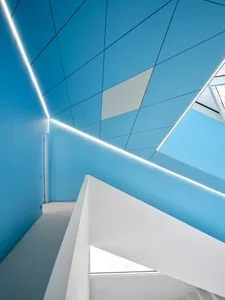 A modern interior design featuring blue walls and white accents.