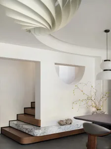 Modern interior design featuring a marble staircase and minimalist decor.