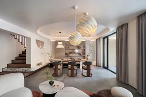 A modern interior living and dining area with minimalist design features and contemporary furniture.
