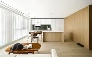 A modern living room with wooden furniture and glass elements.