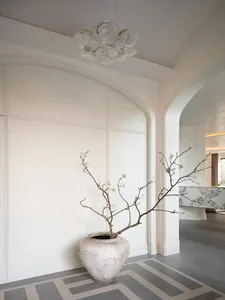 Modern lobby interior with white walls, concrete flooring, and a marble reception counter