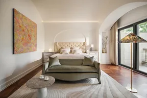 A minimalist bedroom with a modern touch, featuring fabric furniture and a contemporary color palette.