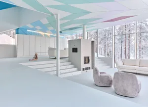 A modern minimalist living room with a concrete floor, large windows, and white furniture.
