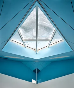 Interior view of a modern office with a glass ceiling showcasing sleek, contemporary design elements.