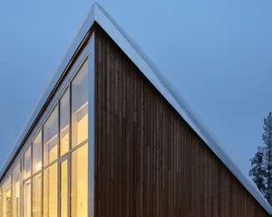 Image of a modern office building exterior with wood siding and large windows.