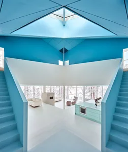 A modern living room with a white floor, blue ceiling, and modern furniture.