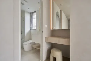 Minimalist bathroom featuring concrete materials, focused lighting, and modern design elements.