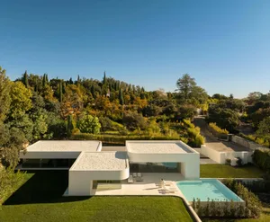 Modern residential home featuring glass, concrete, and stone materials.