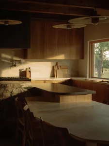 A modern kitchen with concrete countertops and minimalist design.