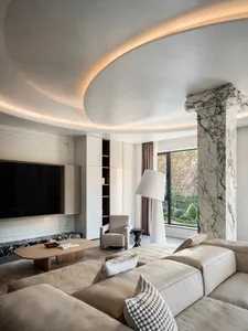 A modern living room with marble accents and a cozy sectional sofa.