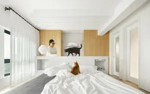 A modern minimalistic bedroom featuring white bedding and curtains, and a black cat on a wooden counter.