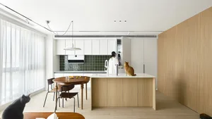 A modern residential kitchen featuring wooden and laminate finishes with a central island.