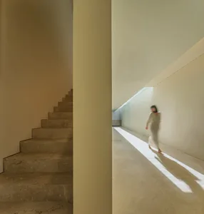 A minimalist modern residential interior with marble stairs and corridor.