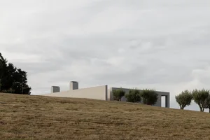 A modern building constructed with concrete materials, featuring a minimalist design.
