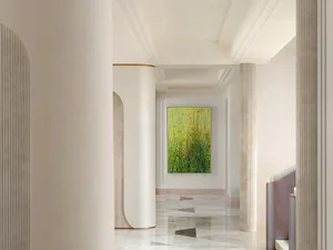 A modern interior corridor with marble columns and a green and yellow abstract painting.
