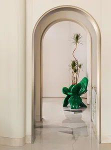 A modern living room featuring marble flooring and a sleek, contemporary cactus-inspired chair with a tall, tall plant in a v
