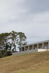 Modern residential house with concrete walls and a flat roof.