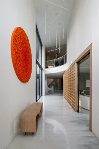 A modern residential corridor featuring white marble floors.