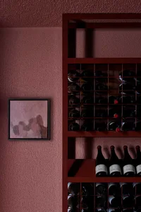 Modern interior design featuring a metal wine cellar grid.