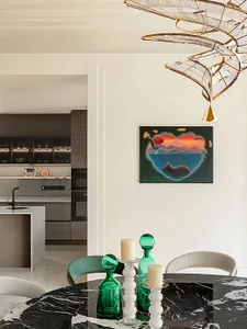 Modern kitchen with marble countertops and a minimalist design.