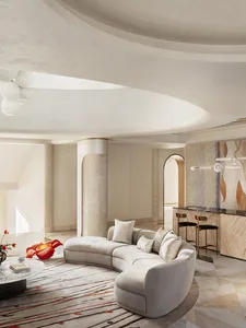 White marble and fabric modern living room with curved sofa and round coffee table.