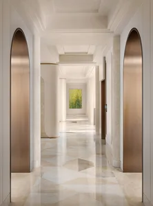 A modern luxury corridor adorned with marble finishes and elegant design elements.