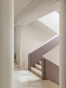 Modern staircase with marble walls and floors.