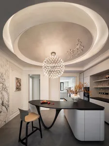 Modern minimalist kitchen with white walls, black countertop, and industrial lighting.