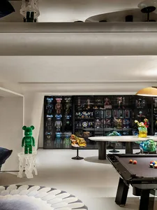 A modern playroom featuring concrete, glass, and metal elements.