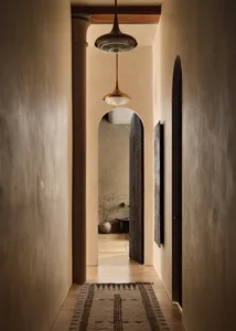 A minimalist hallway with concrete walls, wooden elements, and a rug.