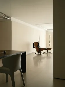 Modern interior design with taupe-colored flooring and a wooden chair.