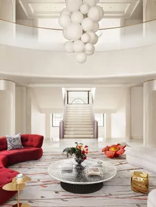 Modern lobby interior with white lighting, red sofas, and white carpet
