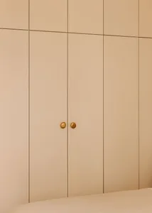 A modern, minimalist wardrobe with neutral colors and simple, elegant design.