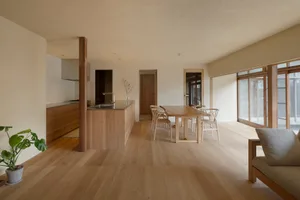 A minimalist residential interior with wooden elements and a spacious, open layout.