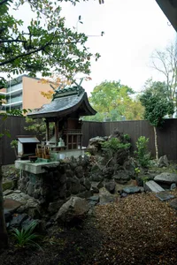 Traditional Japanese courtyard with a stone altar and surrounding rocks and plants