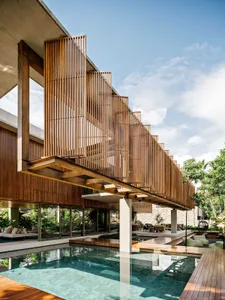 Modern architectural exterior with a wooden structure and a pool.