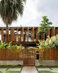 Modern architectural building with wooden exterior and large windows.