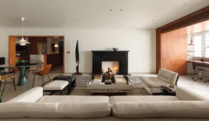 A spacious modern living room with natural fiber accents and a fireplace.