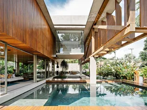Modern residential architecture featuring extensive use of wood and glass materials.