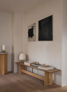 A minimalist living room featuring oak furniture and neutral tones.