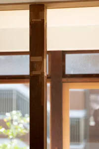 A close-up view of a modern interior designed with a wooden column as a central structural element.