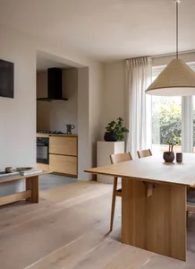 A modern kitchen dining room featuring wooden furniture and flooring.